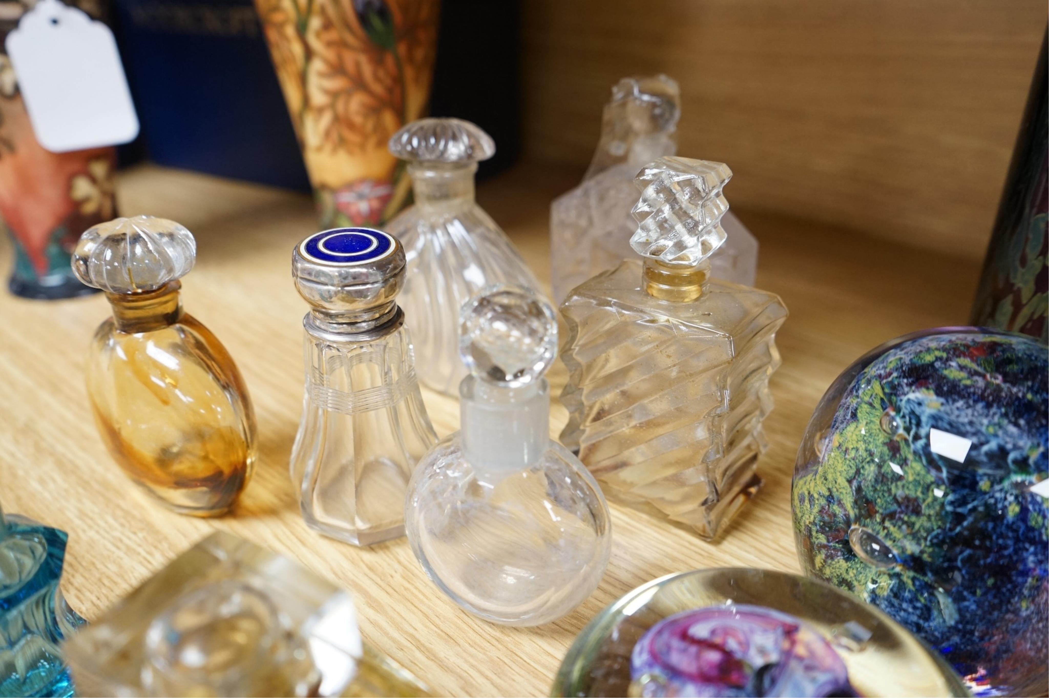 A collection of scent bottles, cranberry glass salts, three glass paperweights and a vase. tallest 18cm high